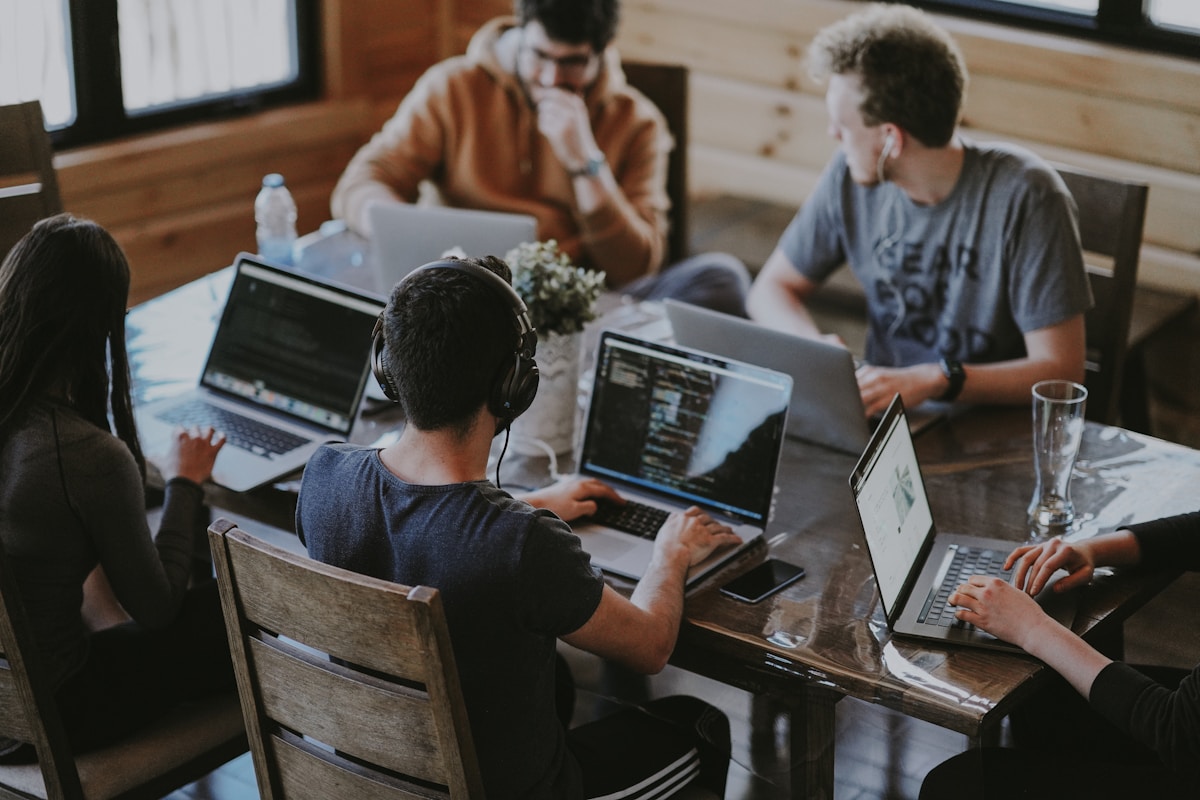 Business team collaborating around a table with laptops in a modern office
